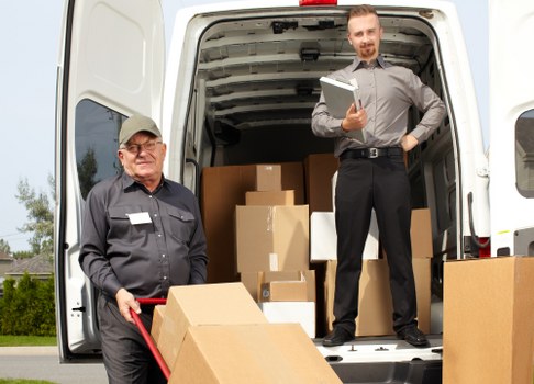 Movers preparing a safe relocation with protective gear and equipment