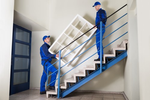 Movers handling items from a terrace house in Belsize Park