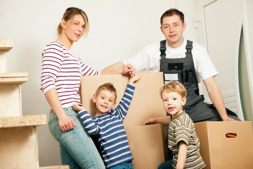 Removalists navigating stairs and access in a Belsize Park apartment building