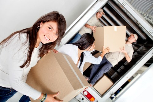 Loading household furniture into a moving truck in Belsize Park
